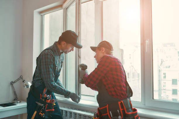 Portrait of mature men wearing uniform standing indoors and installing new windows in the apartment. Horizontal shot